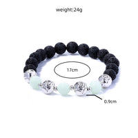 Glowing Faith Bracelet – Black Volcanic Stone with Luminous Beads & Metal Accents (Unisex)