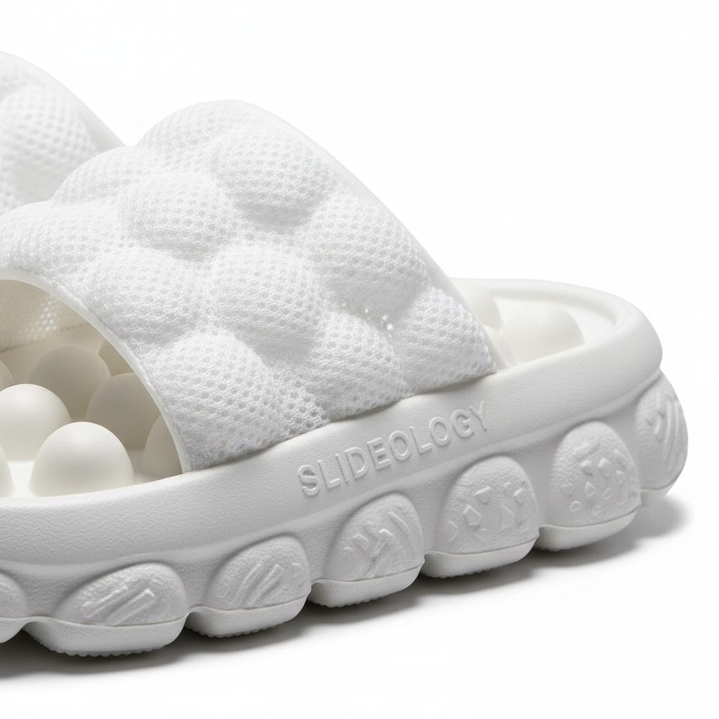 Close-up of massage mesh bubble slides showing anti-skid sole and mesh upper