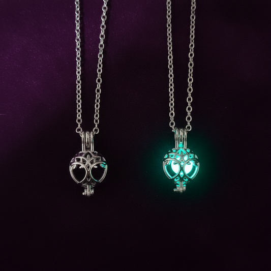 Tree of Life necklace flat lay dark velvet showing metallic and glowing versions