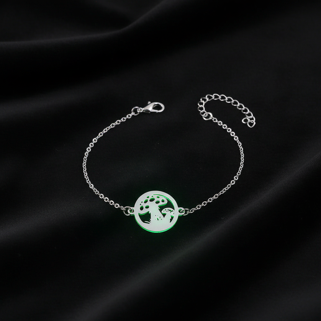 Glow-in-the-dark round brass mushroom bracelet on dark velvet with green glow effect